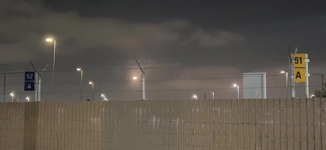 Banking In Low: A Plane Turns Over the City at Night