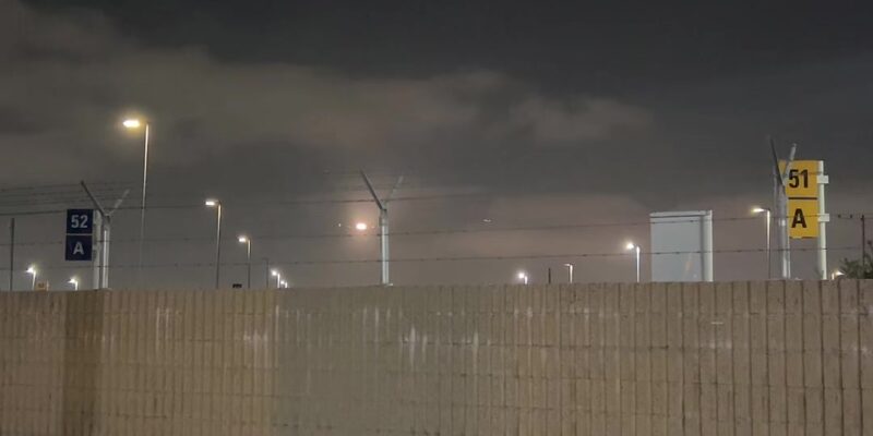 Banking In Low: A Plane Turns Over the City at Night